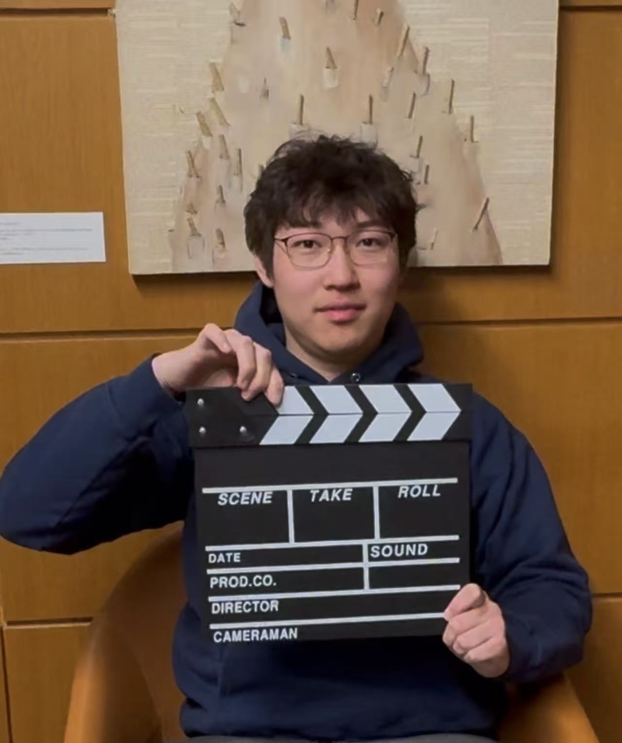 Zihao (Gary) Wang holding a film clapperboard